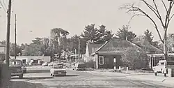 View of a suburban road with a small building
