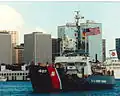Original USCG caption: "Solid Gold! Woodrush returns to port after the final battle problem for REFTRA 92 earning a 5th consecutive clean sweep!"; 1992.