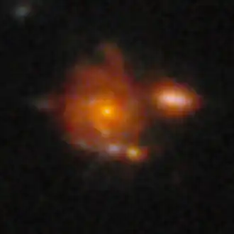 The image of Zhúlóng, the most distant spiral galaxy discovered to date. It has remarkably well-defined spiral arms, a central old bulge, and a large star-forming disk, resembling the structure of the Milky Way.